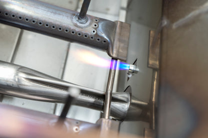 The aog flame throwing ignition system lighting the stainless steel burners on the aog gas grills