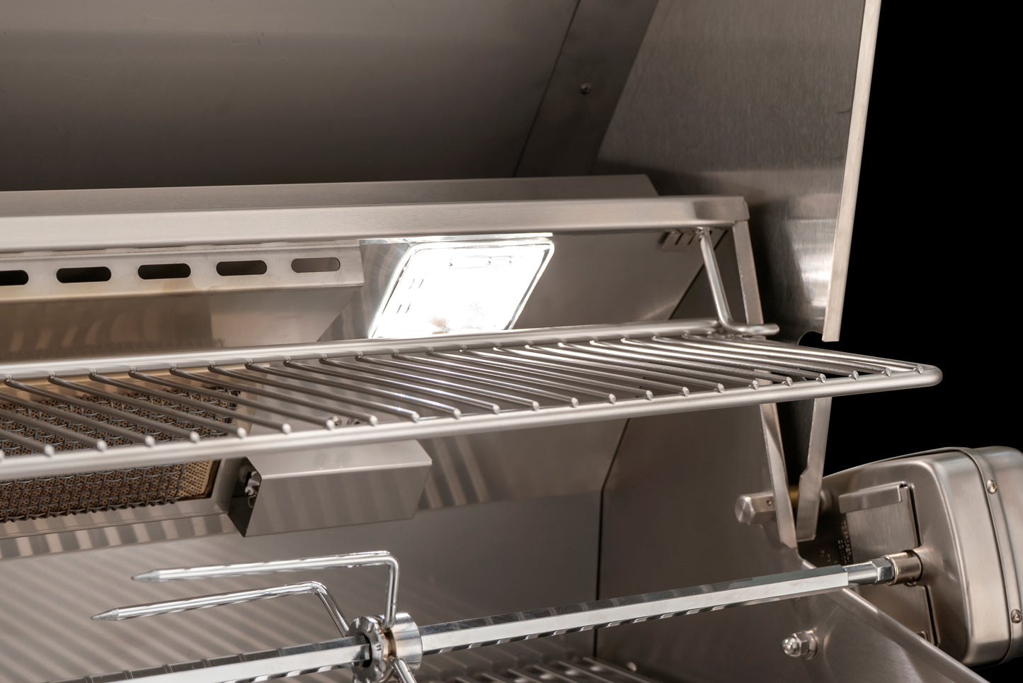 The aog lights series grill internal lights with the rotisserie rod and motore. The removable warming rack is shown in image which is not normally installed during rotisserie operation.